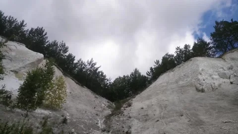Rain cloud flying over chalky slopes overgrown with fir Stock Footage 133251102