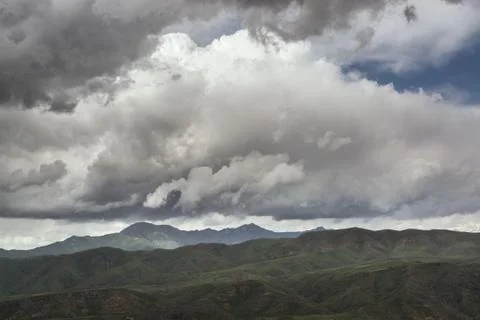 Rain cloud over the mountains. Stock Photos
