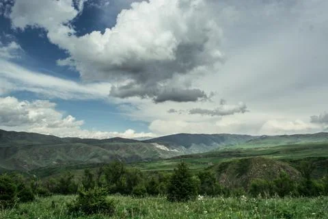 Rain cloud over the mountains. Stock Photos