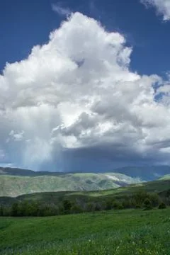 Rain cloud over the mountains. Stock Photos