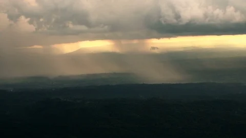 The rain cloud raining over the tropical mountain in sunset time at Phu Hin R Stock Footage 83561273