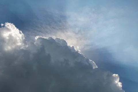 Rain cloud with the rays of the sun Stock Photos