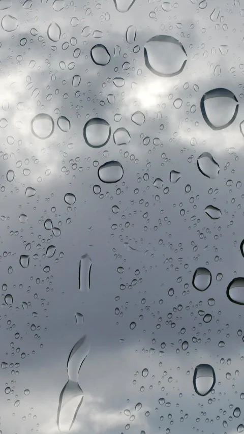 Rain cloud time lapse and water drops on glass panel 動画素材 276319144