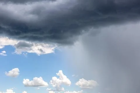 Rain cloud. Weather change. Different climatic situations in a single image. Stock Photos