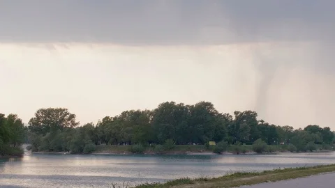 Rain clouds above the lake. In the distance, it can be seen that it is raining. Stock Footage 129103837