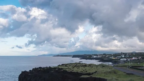 Rain clouds and rainbow are moving in, on coastline Sao Miguel island Time Lapse Video stock 165729982