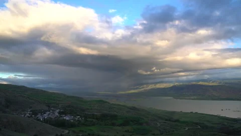 Rain clouds approaching over lake surrounded - Rain Storm and Cloud Approaching Stock Footage 339361938