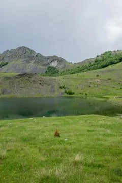 Rain clouds are approaching the mountain lake. Stock-Fotos