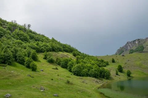 Rain clouds are approaching the mountain lake. Stock-Fotos