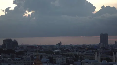 Rain clouds are forming above the city of Bangkok, Thailand during sunset. Video stock 245766701