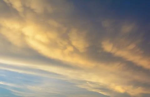 Rain clouds are gathering evening light from the sun as well. Stock Photos
