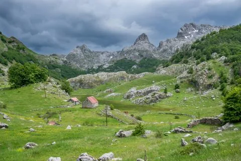 Rain clouds are pushed on the dried up mountain lake. Stock-Fotos