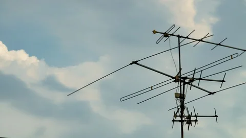 Rain clouds blow quickly in sky, Rain clouds and old TV antennas. Stock Footage 129171472