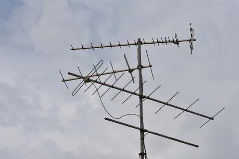 Rain clouds blow quickly in sky, Rain clouds and old TV antennas. Stock Photos