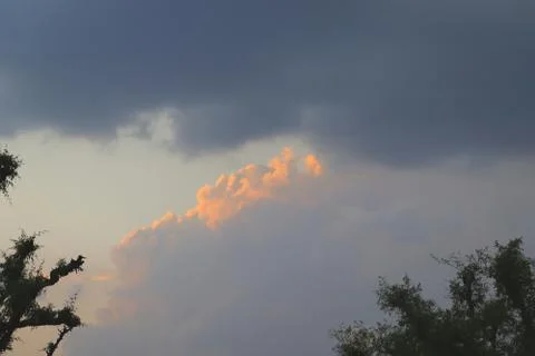 Rain clouds with blue sky and sunrise background theme Stock Photos