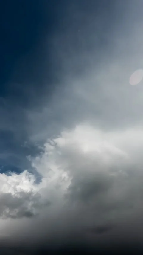 Rain clouds fly away quickly and the blue sky becomes, vertical time-lapse Stock Footage 247994204