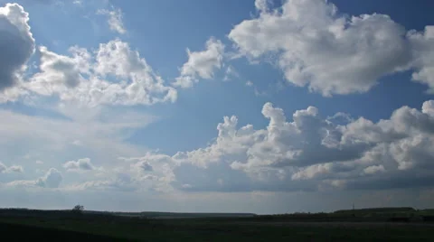 Rain clouds flying on blue sky over field Stock Footage 5089394