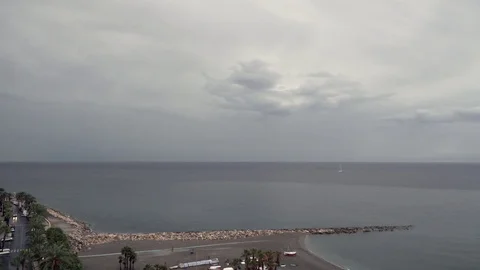 Rain clouds flying over the seaside and getting lighter. Timelapse 4k Stock Footage 81313411