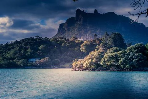 Rain clouds gathering around Mount Manaia with sporadic sunny spots over wate Stock Photos
