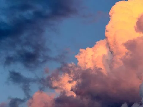 Rain clouds illuminated by the setting sun Stock Photos