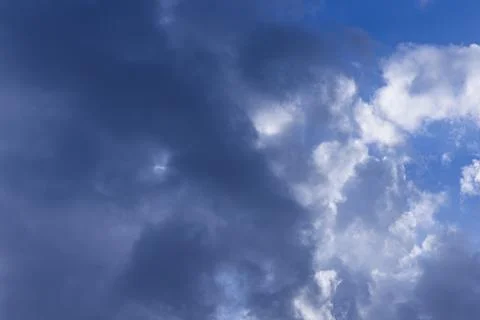 Rain clouds in mid day on blue sky Stockfoto's