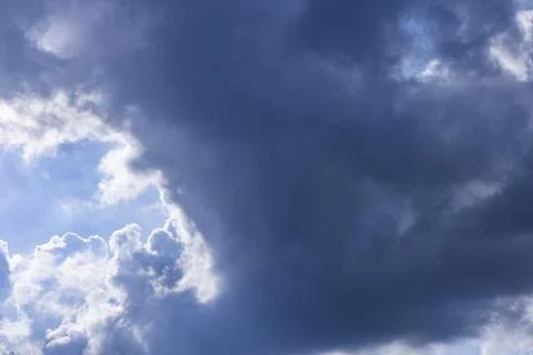 Rain clouds in mid day on blue sky Stockfoto's