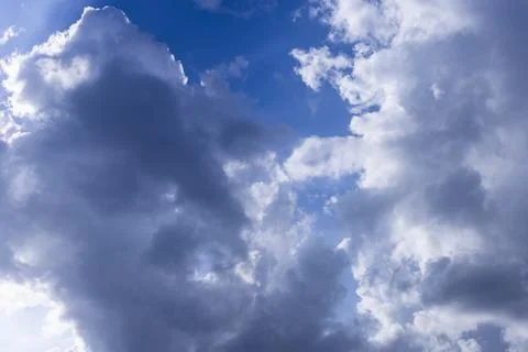 Rain clouds in mid day on blue sky Stock Photos