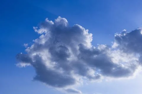 Rain clouds in mid day on blue sky Stockfoto's