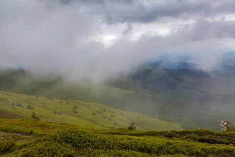 Rain clouds on the mountain top. Stock Photos