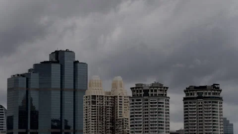 Rain clouds move quickly past tall buildings in the city. Stock Footage 314244277