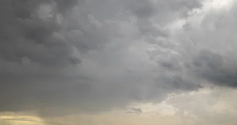 Rain clouds moving fast in dark dramatic stormy sky timelapse shot Stock Footage