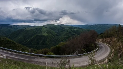 Rain clouds moving quickly over mountains covered with thick forests of decid Stock Footage 95907302