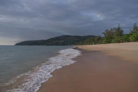 Rain clouds over the beach during sunset Stock Photos