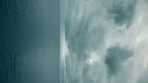Rain clouds over the calm sea. Vertical video Stock Footage 242451512