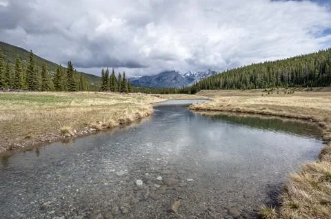Rain Clouds over the Cascade River in Banff Stock Photos