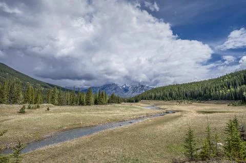 Rain Clouds over the Cascade River in Banff Stock Photos