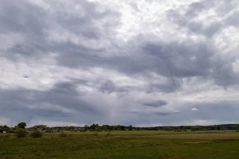 Rain clouds over the field, with a small Virga cloud Foto stock