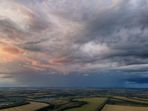 Rain clouds over green fields and lakes. Photos