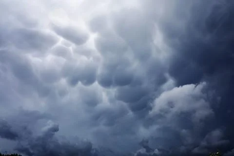 Rain clouds in the sky. Gray dark clouds in the sky. Storm clouds. Stock Photos