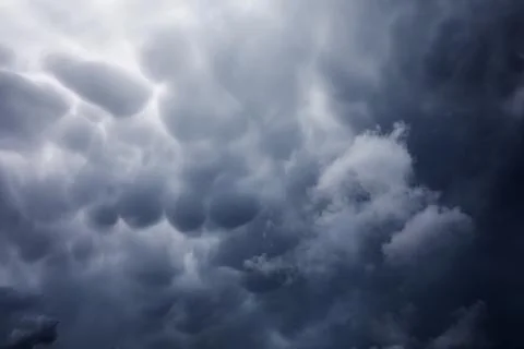 Rain clouds in the sky. Gray dark clouds in the sky. Storm clouds. Stock Photos