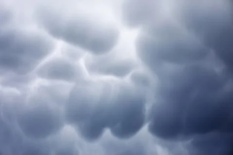 Rain clouds in the sky. Gray dark clouds in the sky. Storm clouds. Stock Photos