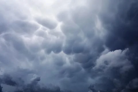 Rain clouds in the sky. Gray dark clouds in the sky. Storm clouds. Stock Photos