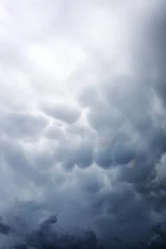 Rain clouds in the sky. Gray dark clouds in the sky. Storm clouds. Stock Photos