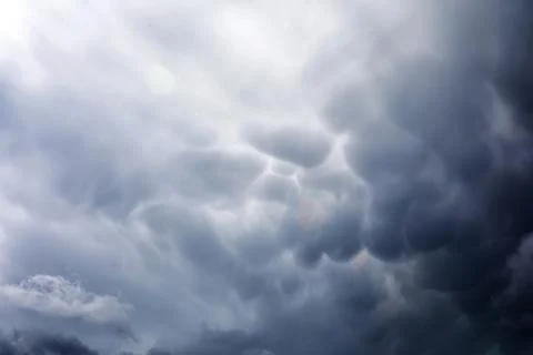 Rain clouds in the sky. Gray dark clouds in the sky. Storm clouds. Stock Photos