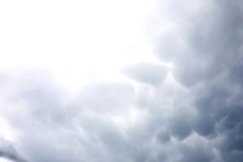 Rain clouds in the sky. Gray dark clouds in the sky. Storm clouds. Stock Photos