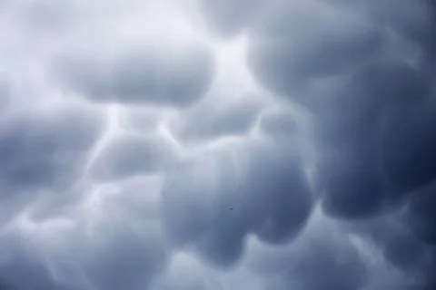 Rain clouds in the sky. Gray dark clouds in the sky. Storm clouds. Stock Photos