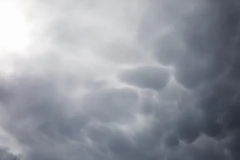 Rain clouds in the sky. Gray dark clouds in the sky. Storm clouds. Stock Photos