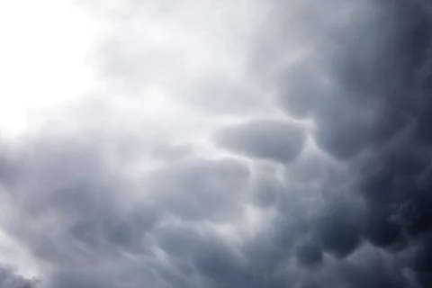 Rain clouds in the sky. Gray dark clouds in the sky. Storm clouds. Stock Photos