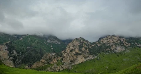 Rain clouds slowly cover the stony mountain slopes. 動画素材 105016869
