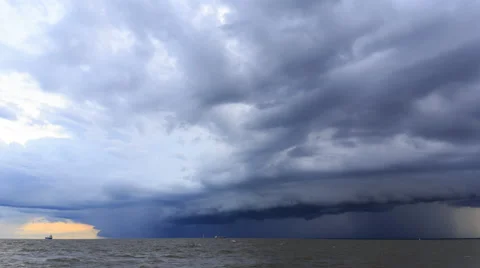 Rain clouds spread across the sky before sunset at sea Stock Footage 68253147